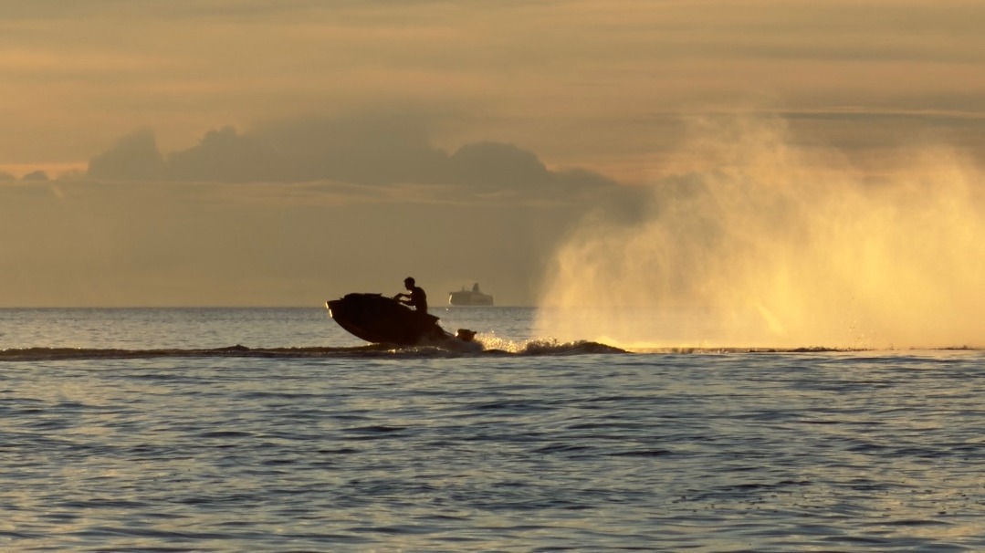 Sea-Doo jetski resting at a wooden dock in warm morning light on the Estonian coast